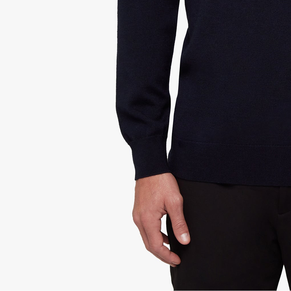 Close-up of a person wearing a dark blue sweater on a white background