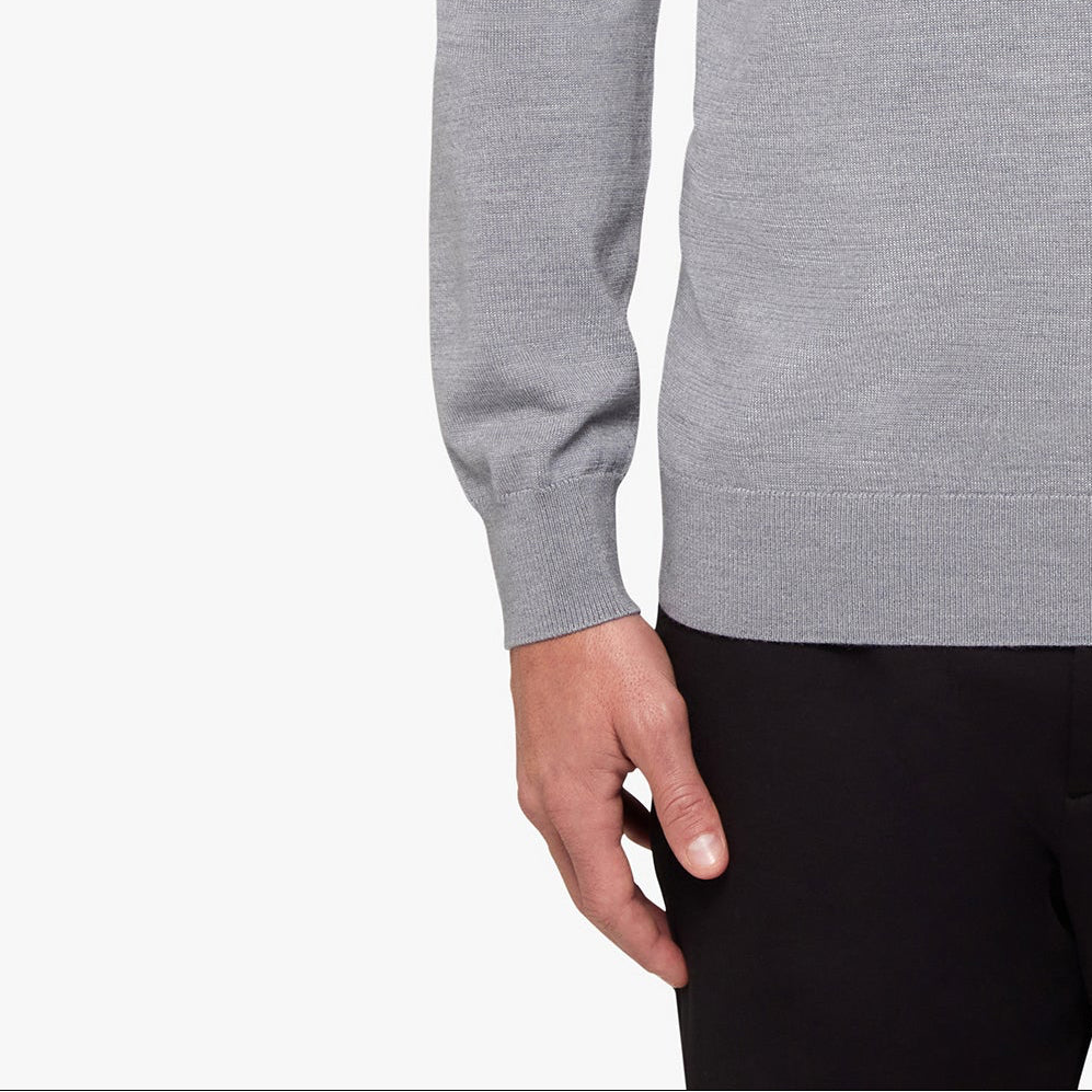 Gray sweater worn by a person on a white background