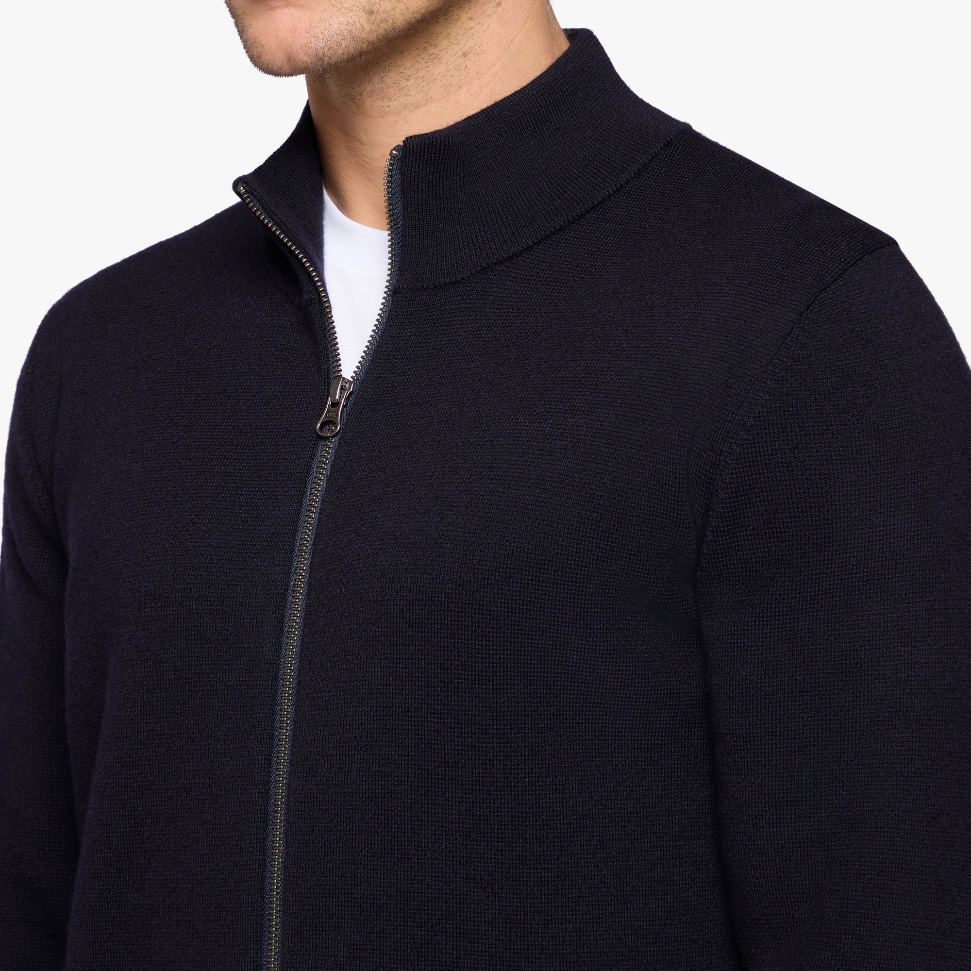Navy blue zip-up sweater worn by a person on a white background
