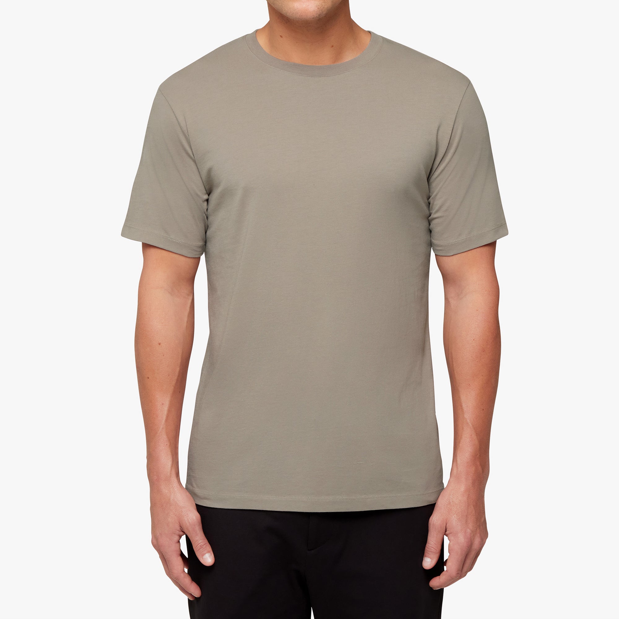Person wearing a plain beige t-shirt on a white background