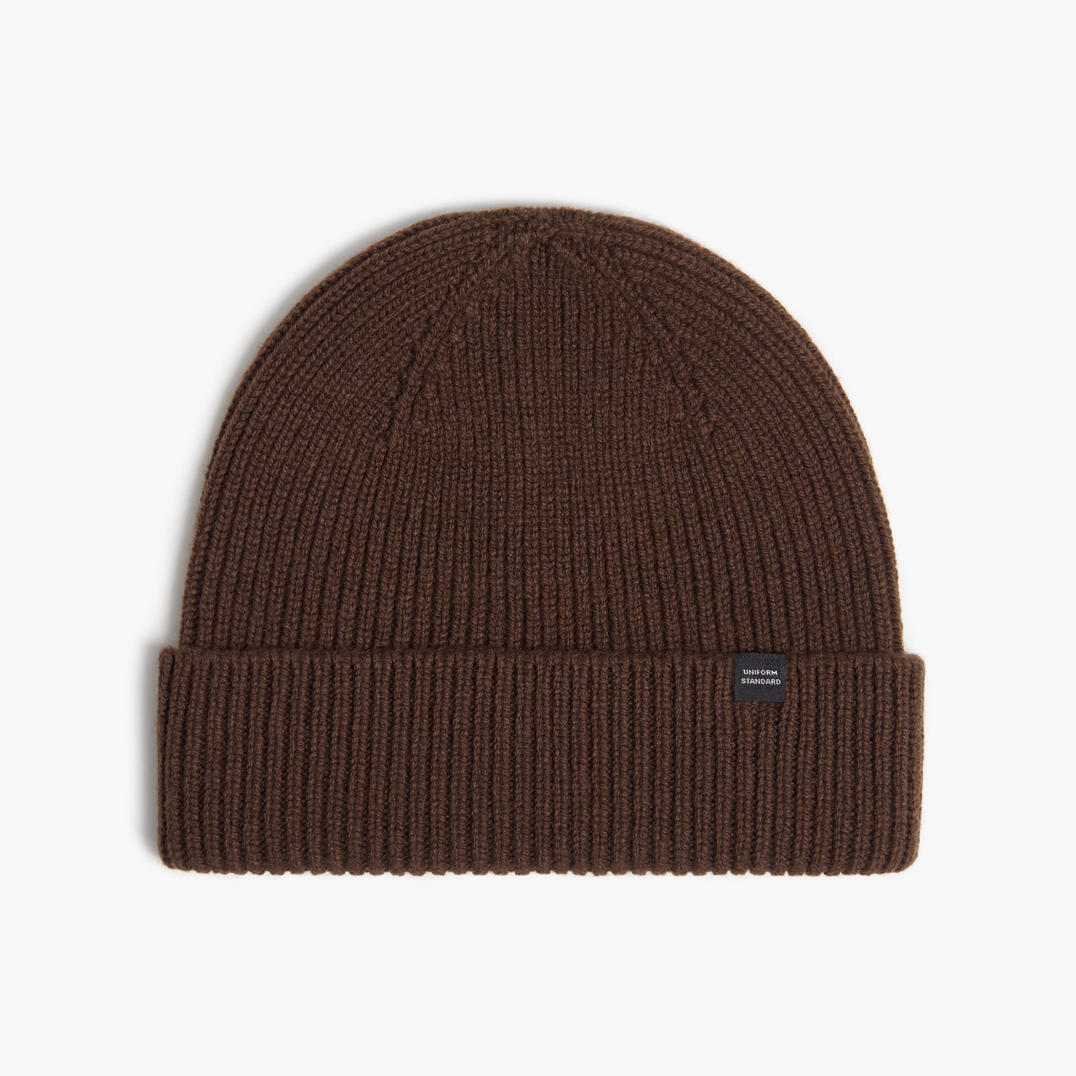 Brown knit beanie with a brand label on a white background